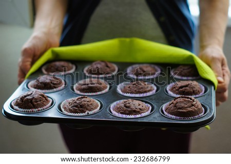 Home made chocolate cupcakes straight from the oven, on a metal tray