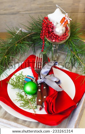 Christmas time table decoration with rose hips and tea with christmas tree branches