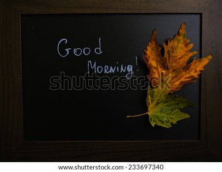 Autumn time, yellow autumnal leaves on the chalkboard with note
