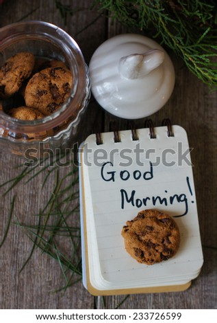 Cup of tea with lemon and cookies on the table with Good morning note