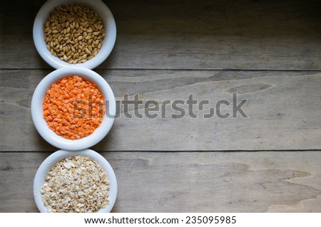 various food ingredients : beans, legumes, peas, lentils in wooden spoon and glass bowls
