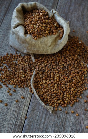 buckwheat groats in a burlap bag and wooden spoon