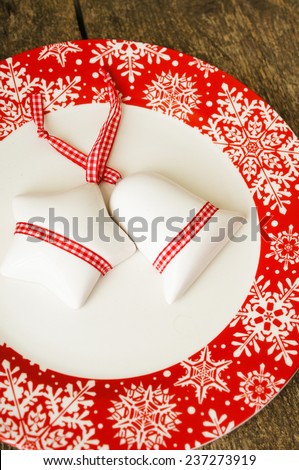 Christmas serving with red snowflake ornament plate and candle, with other christmas decorations