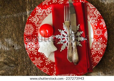 Christmas serving with red snowflake ornament plate and candle, with other christmas decorations