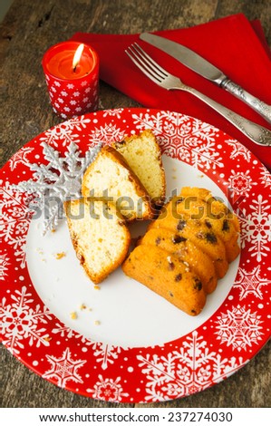 Christmas cake with spices, cinnamon and anise star,on th ered snowflake ornament plate
