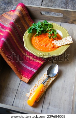 Healthy dinner, carrot cremme soup on the old wooden table