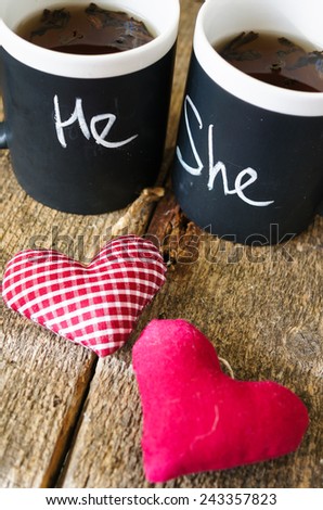 Cup with words He and She written with chalk and heart
