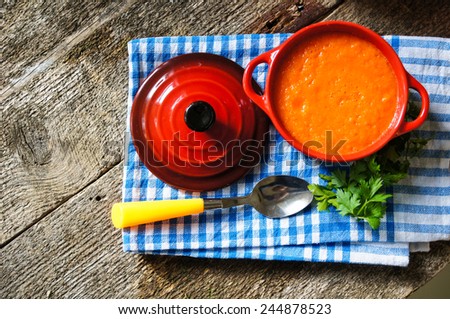 Healthy dinner, carrot cream soup on the old wooden table