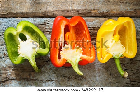 Fresh vegetables, different colors of bell pepper on the wooden background