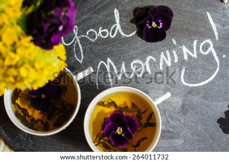 Cup o tea and spring flowers with good morning note