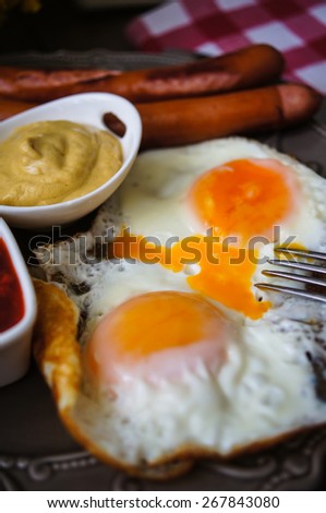 Lunch time with eggs and fried sausages