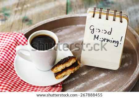 Cup of black coffee and Good morning note