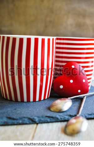 Red tea cup with tea and lemon on the old wooden background with note