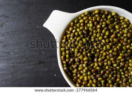 Green bean or mung bean on the black stone background