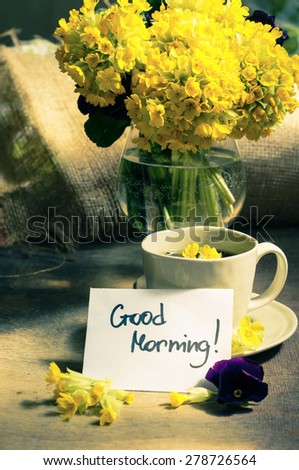 Cup o tea and spring flowers with good morning note