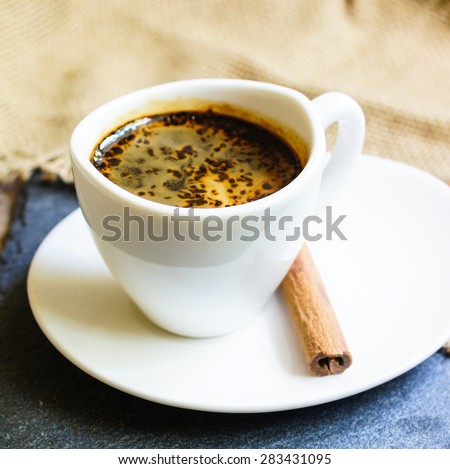 Coffee time, cup of black coffee and cinnamon and anise spices, Good morning note