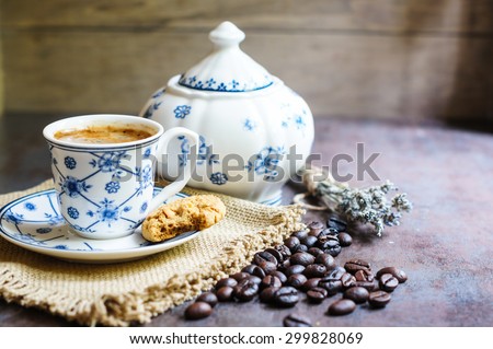 Vintage cup with black coffee, dry lavender flowers and coffee beans