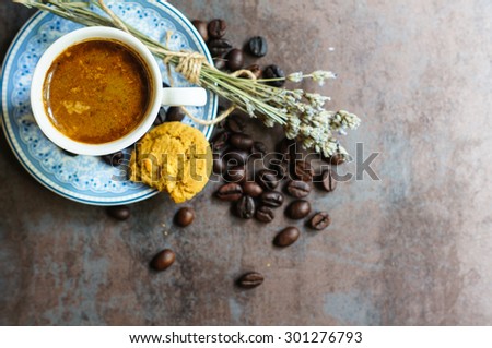 Vintage cup with black coffee, dry lavender flowers and coffee beans