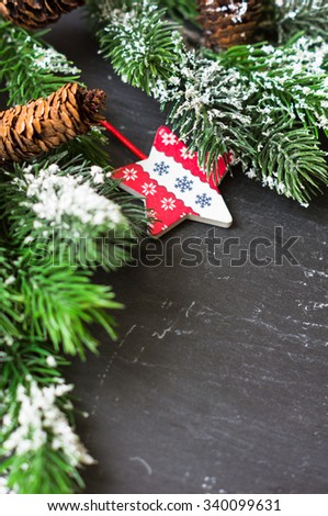 Christmas time interior decorations on the black background with fir tree, pine cones, angels and christmas socks