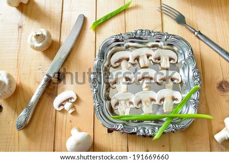 raw champignons on silver tray