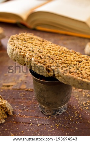 Fresh baked chocolate-coffee biscottis with poppy seed on wooden background