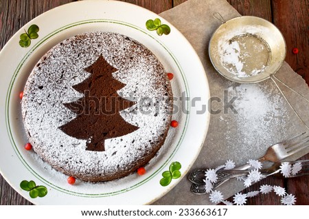 Homemade chocolate Christmas cake sprinkled with sugar powder