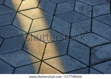 texture of the tile with a ray of sunshine