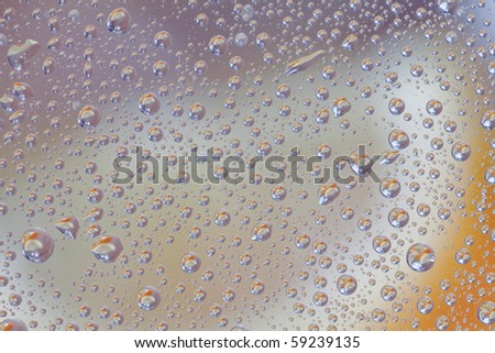 drops on glass with the reflection of the fruit orange