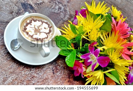 Fresh cup of coffee with flowers