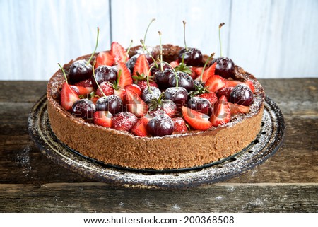 Bright chocolate berry cake on old ceramic plate