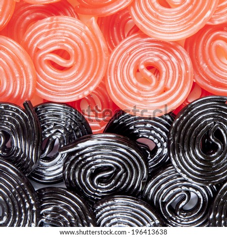 a background of black and red licorice wheels