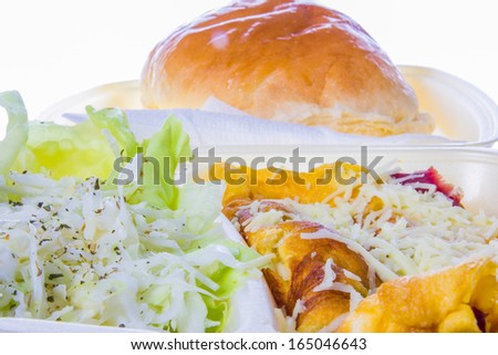 portion of meal  with grated cheese, eggs, salad and with bread