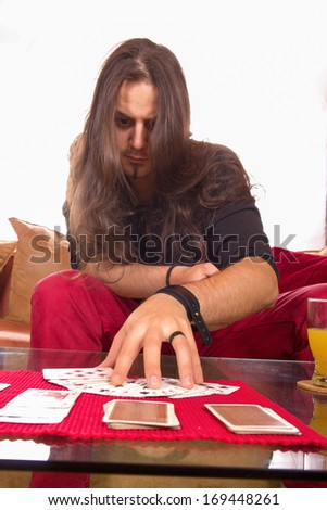 man with a deck of cards on the table showing trick