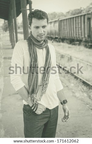 young male model posing at old train station