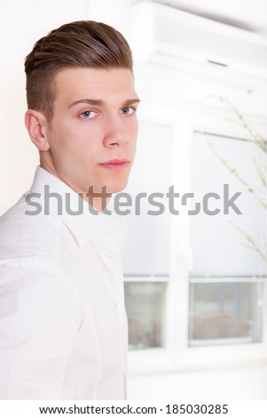 young handsome male model with modern haircut posing