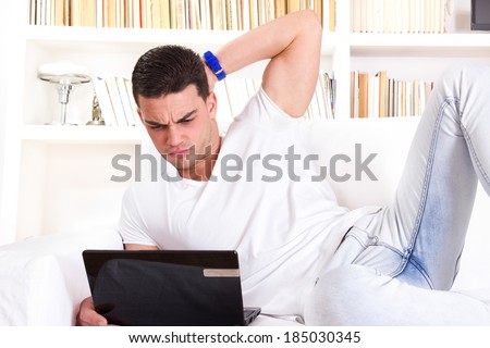 nervous man using laptop having problems with communication and internet connection