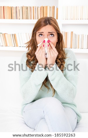 sick woman caught cold blowing her nose into handkerchief having flu or allergy