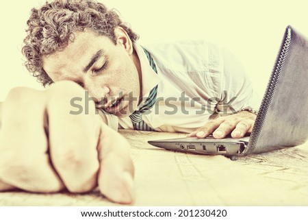 photo of exhausted, sleeping and overworked business man on office desk at his work, vintage high contrast style