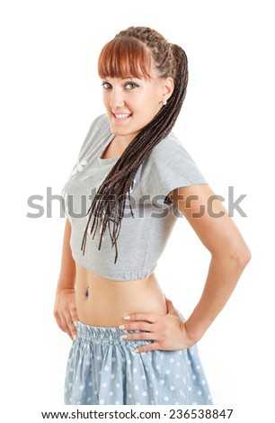 young smiling pretty girl or woman in mini skirt and short t-shirt posing on white background. Concept of modern fashion trend