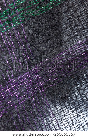 Wool threads texture of knitted scarf , Black and purple details of woolen shawl background