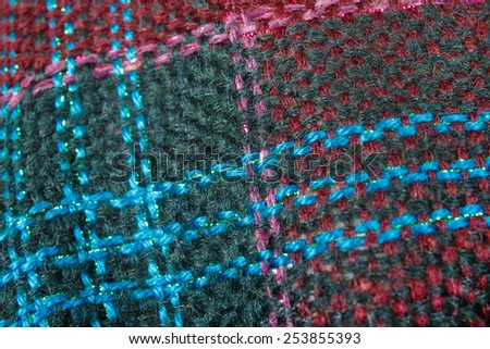 Wool texture tartan background of winter fashion scarf , Woolen fabric knitted of different colors as fashion accessory
