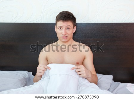 Impotent man worrying about his penis and erection failure , Surprised young man havingtrouble with potency and prostate