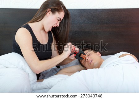 Young girl being angry on snoring boyfriend. Unhappy woman and her snoring husband. I still hear you loud. Person disturbed by snores trying to stop that with clothespin on nose and get restful sleep.