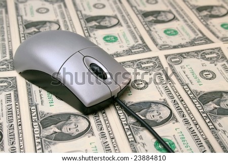 Computer mouse on money concept shot for finances or shopping