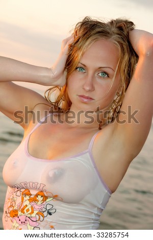 stock photo Sexy woman lying in the sea in wet clothes