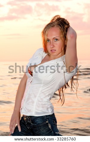 stock photo Sexy woman relaxing in the sea in wet clothes