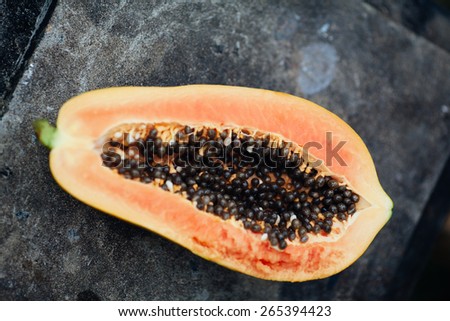 sliced papaya fruit on black background