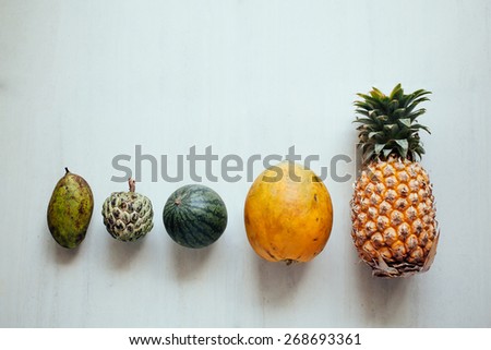 Assortment of fruits on white background. Exotic fruits variety on white table. Sliced fresh fruits on table
