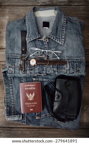 Blue Jeans and accessories.Overhead view of man essentials to travel.