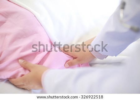 Hand of doctor comforting female patient.